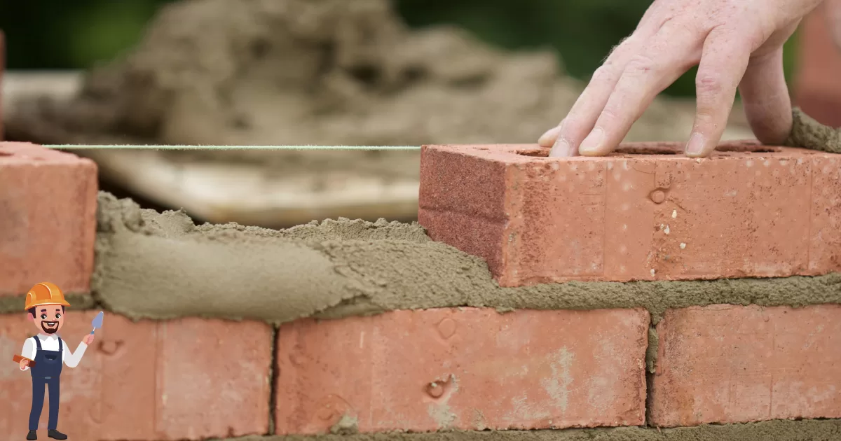 imagem que exemplifica a construção do site, possui a foto de uma parede de tijolos em construção e um adesivo de pedreiro